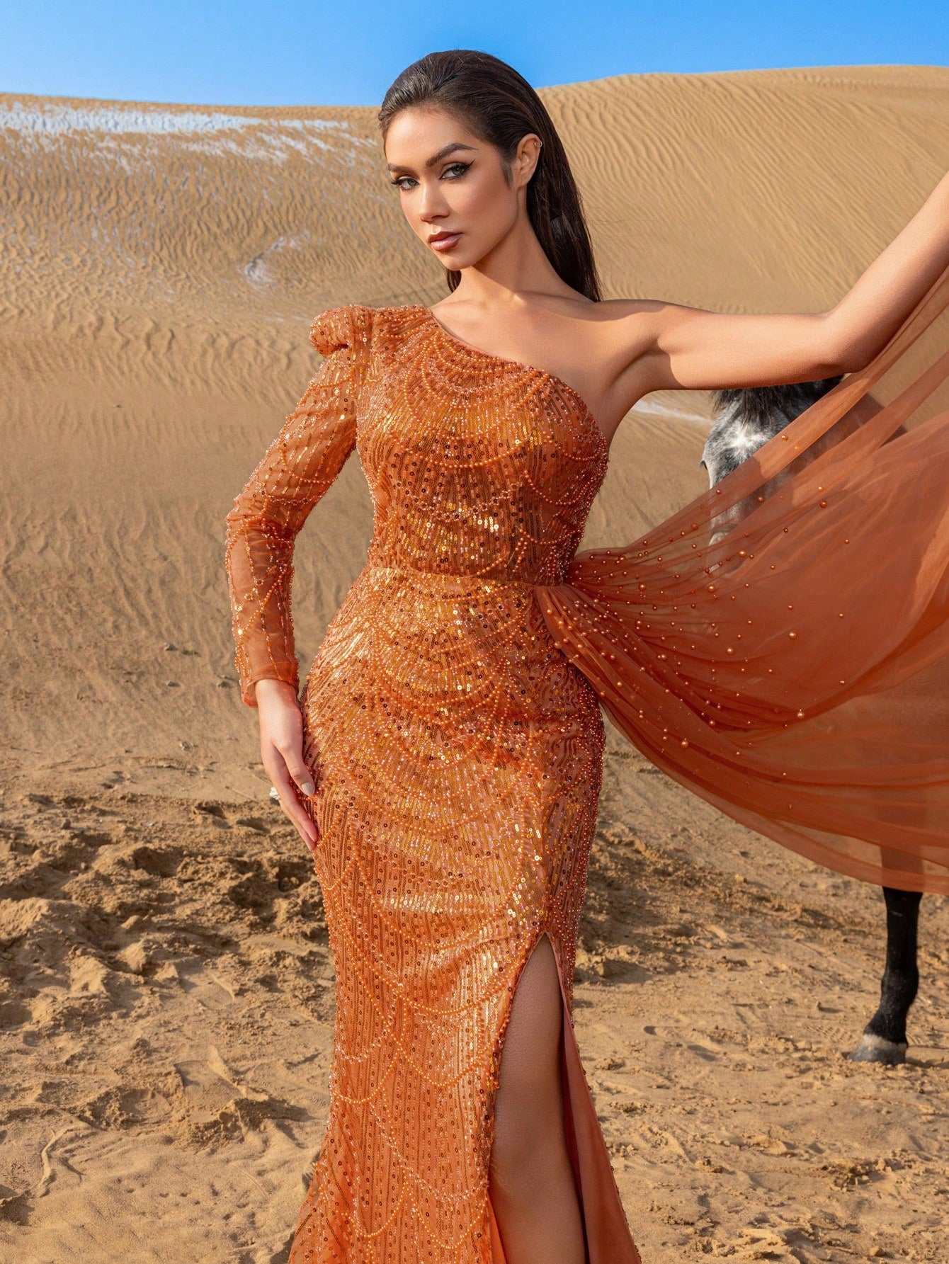 Elegant One-Shoulder Beaded Evening Gown with Dramatic Long Sleeves, Back-Bow Accent, High-Thigh Slit & Cascading Side Panel Mermaid Dress